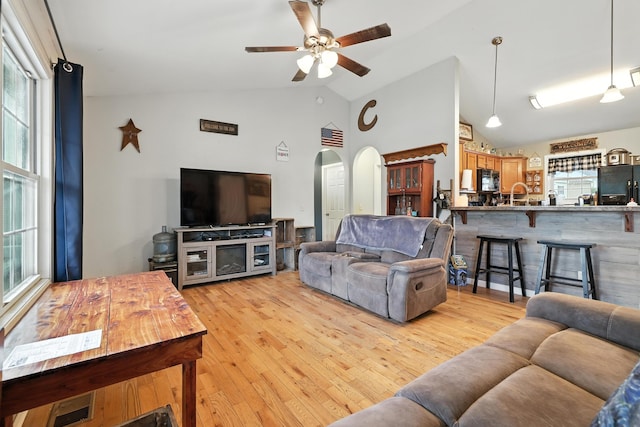 14975 Woodcreek Ln, Timberville, VA 22853 - living area featuring healthy amount of natural light, arched walkways, ceiling fan, vaulted ceiling, and light wood finished floors