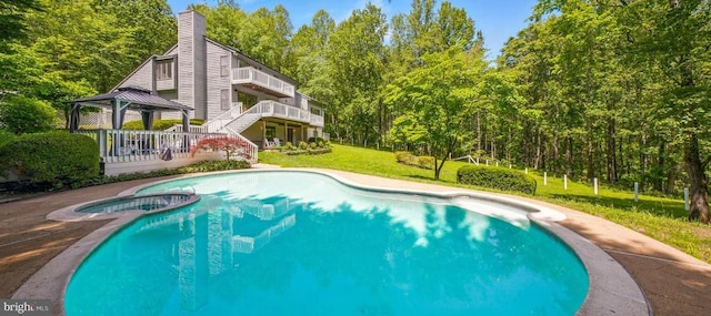  - view of pool with a gazebo, a yard, and a pool with connected hot tub