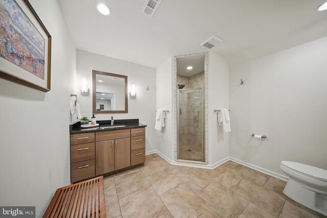  - bathroom featuring vanity, a shower stall, toilet, recessed lighting, and baseboards