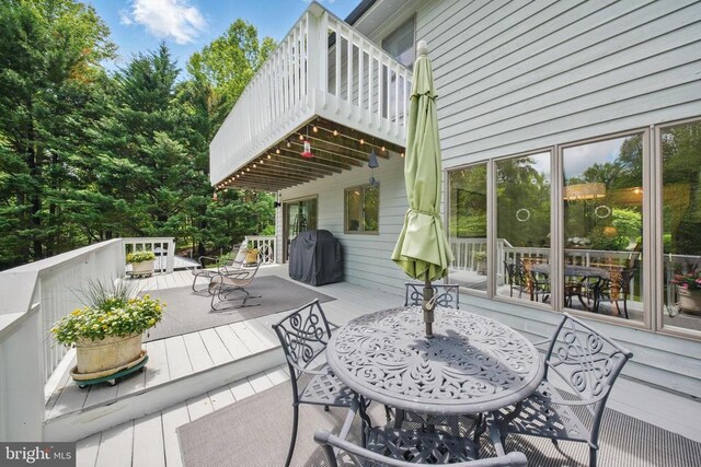  - view of patio featuring a grill, a deck, and outdoor dining area