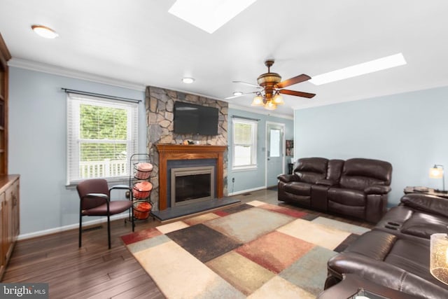8314 Old Mill Ln, Spotsylvania, VA 22551 - living room featuring a skylight, ornamental molding, plenty of natural light, and a stone fireplace