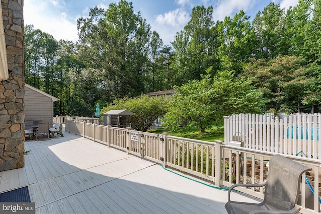 8314 Old Mill Ln, Spotsylvania, VA 22551 - wooden deck with outdoor dining space and view of wooded area