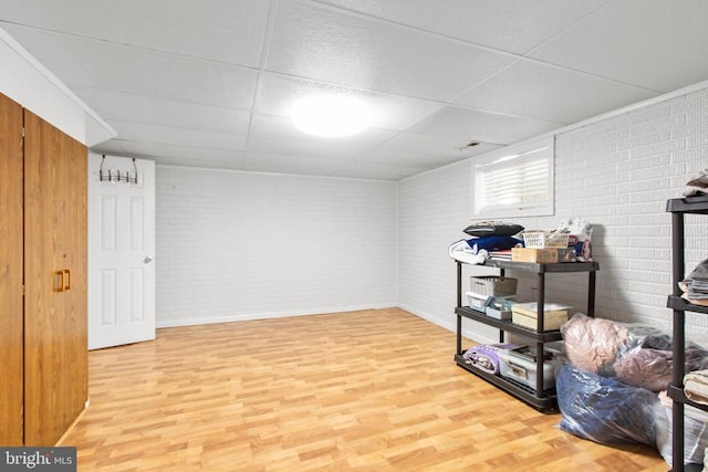 8314 Old Mill Ln, Spotsylvania, VA 22551 - below grade area with light wood-style flooring, brick wall, and a paneled ceiling