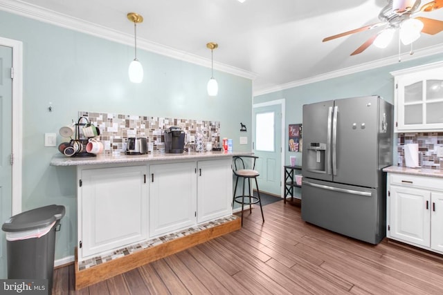8314 Old Mill Ln, Spotsylvania, VA 22551 - kitchen featuring stainless steel refrigerator with ice dispenser, decorative backsplash, crown molding, ceiling fan, and white cabinetry