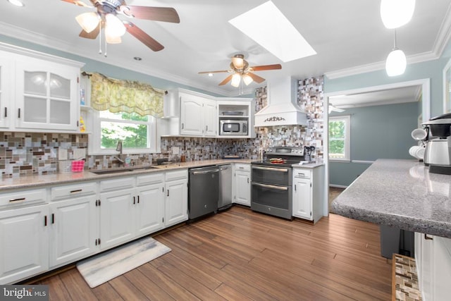 8314 Old Mill Ln, Spotsylvania, VA 22551 - kitchen with stainless steel appliances, premium range hood, a ceiling fan, white cabinets, and ornamental molding