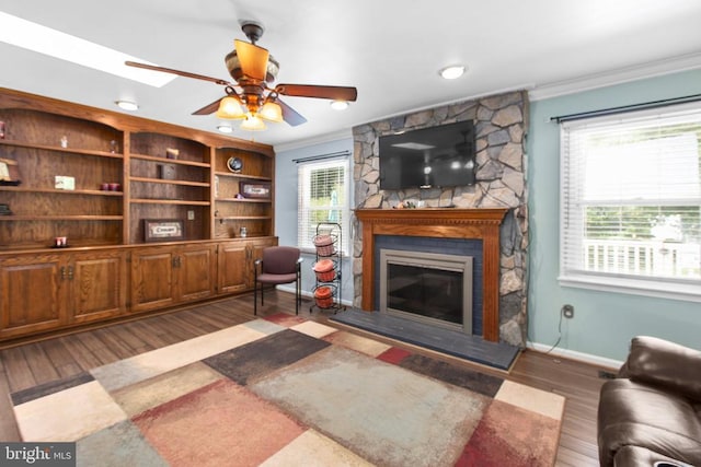 8314 Old Mill Ln, Spotsylvania, VA 22551 - living area featuring ornamental molding, a stone fireplace, wood finished floors, and ceiling fan