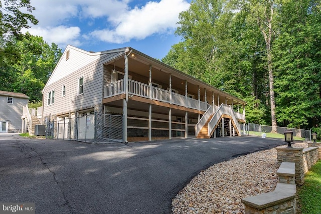8314 Old Mill Ln, Spotsylvania, VA 22551 - view of front of house with stairway, a garage, and asphalt driveway