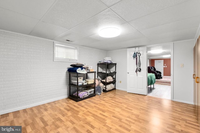8314 Old Mill Ln, Spotsylvania, VA 22551 - basement with wood finished floors, a drop ceiling, and brick wall