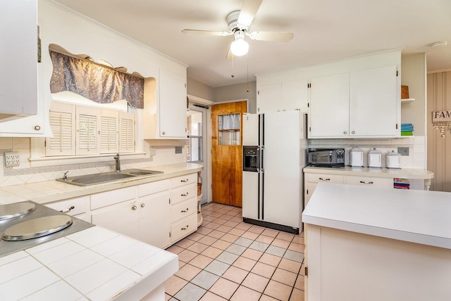 5213 Rawley Pike, Rockingham, VA 22801 - kitchen featuring white refrigerator with ice dispenser, tasteful backsplash, black microwave, white cabinetry, and a ceiling fan