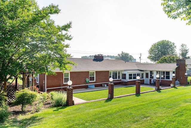 5213 Rawley Pike, Rockingham, VA 22801 - rear view of property featuring a chimney, brick siding, and a yard