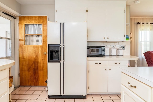 5213 Rawley Pike, Rockingham, VA 22801 - kitchen with white refrigerator with ice dispenser, light countertops, white cabinets, and light tile patterned flooring