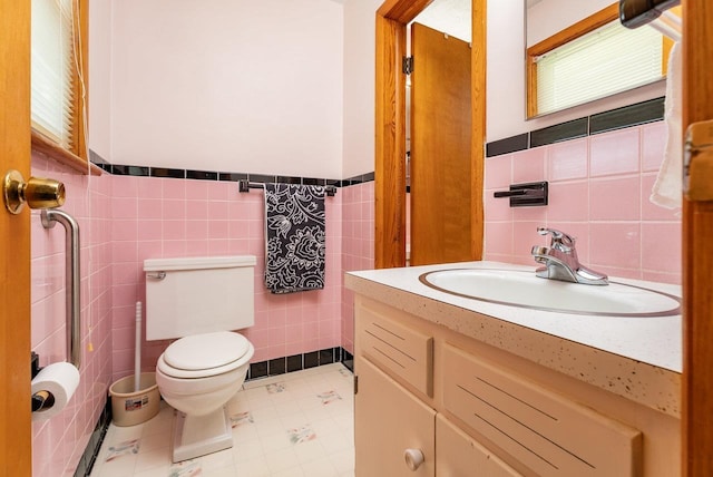 5213 Rawley Pike, Rockingham, VA 22801 - bathroom featuring tile walls, vanity, tile patterned flooring, and a wainscoted wall