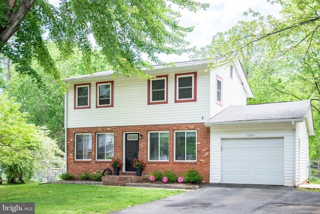 view of front of home featuring a garage, brick siding, and driveway