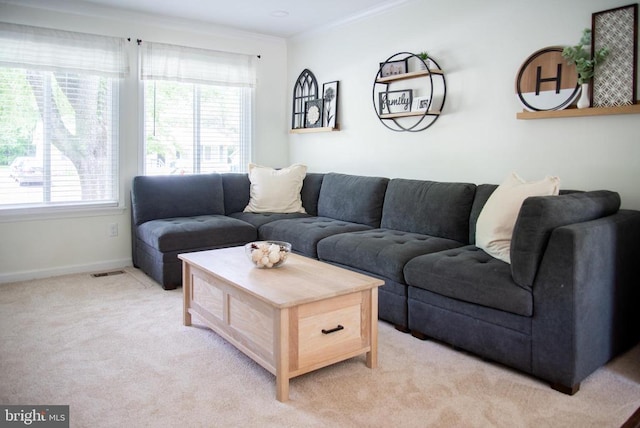 living area featuring ornamental molding, light colored carpet, and baseboards