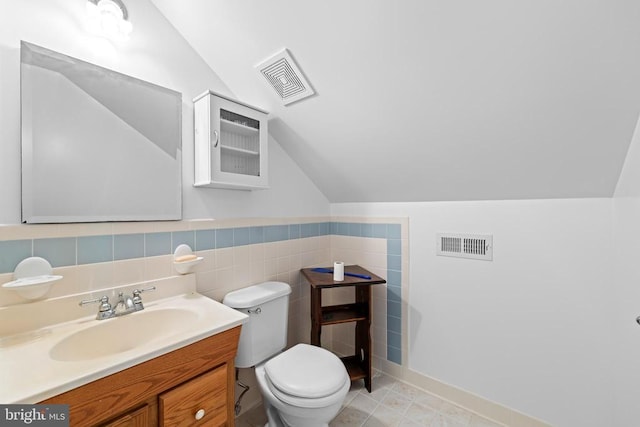60 Mountain Breeze Ln, Syria, VA 22743 - bathroom with vaulted ceiling, toilet, vanity, and tile walls