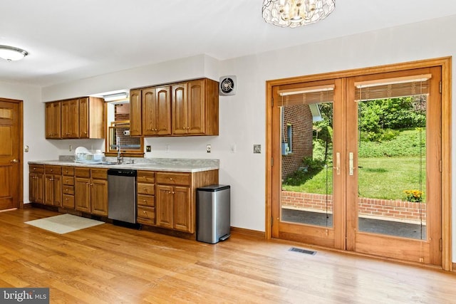 60 Mountain Breeze Ln, Syria, VA 22743 - kitchen with stainless steel dishwasher, light wood finished floors, light countertops, and brown cabinets