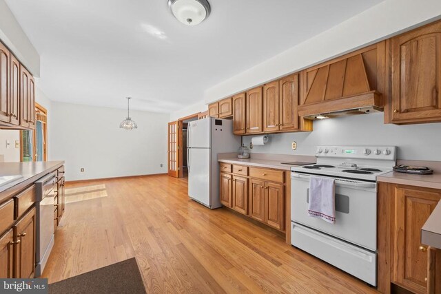 60 Mountain Breeze Ln, Syria, VA 22743 - kitchen featuring white appliances, custom range hood, brown cabinets, light countertops, and light wood-style flooring