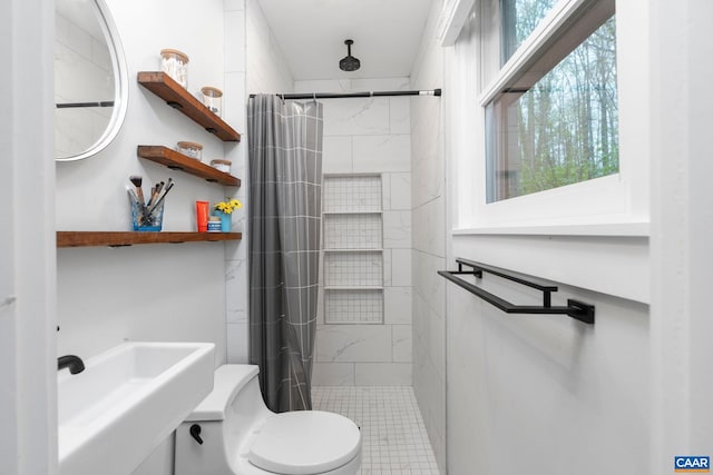 full bath featuring a sink, toilet, and a shower stall