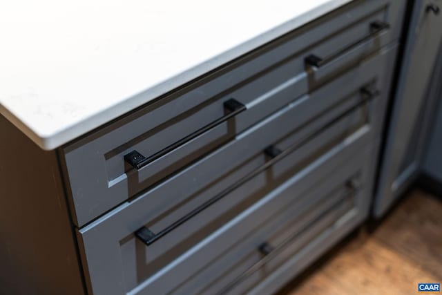 details with light countertops and wood finished floors
