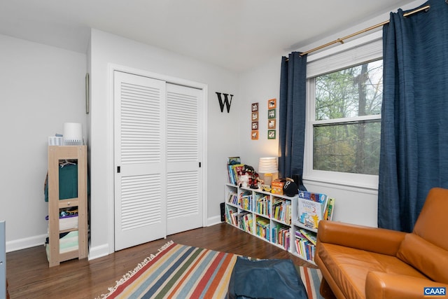 living area featuring wood finished floors and baseboards