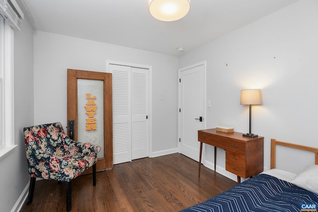 bedroom featuring a closet, wood finished floors, and baseboards
