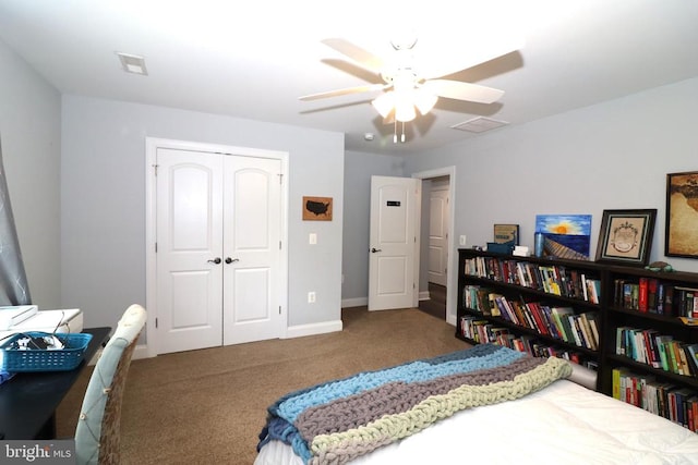 carpeted bedroom featuring a closet, a ceiling fan, and baseboards