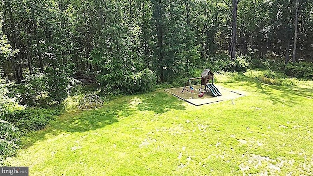 view of grassy yard with a playground