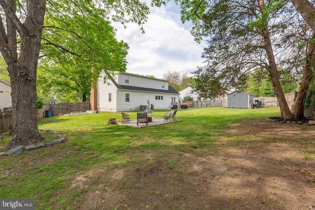 12203 Mcclain St, Fredericksburg, VA 22407 - view of yard with an outdoor structure, a storage shed, an outdoor fire pit, central AC, and a fenced backyard