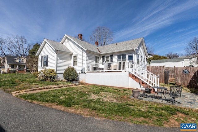 1700 Monticello Rd, Charlottesville, VA 22902 - view of front facade with a chimney, fence, a patio area, a shingled roof, and a front yard
