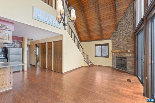 19 Hawks Pl, Palmyra, VA 22963 - unfurnished living room with wood finished floors, a high ceiling, visible vents, baseboards, and a stone fireplace