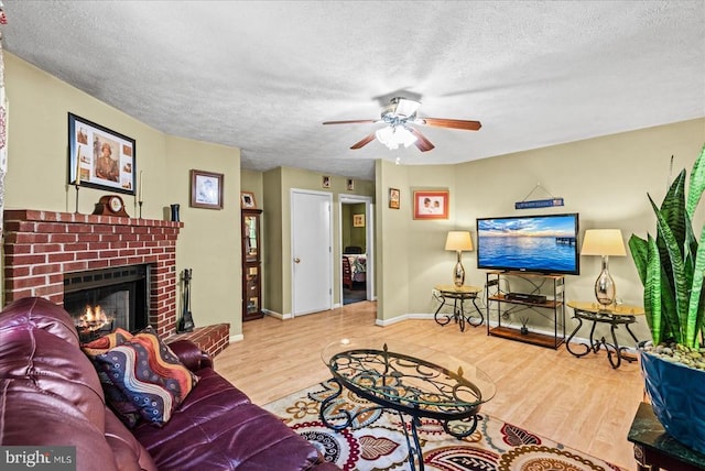 54 Courthouse Mountain Rd, Madison, VA 22727 - living room with a textured ceiling, a brick fireplace, a ceiling fan, and wood finished floors