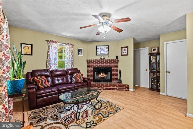 54 Courthouse Mountain Rd, Madison, VA 22727 - living area featuring a ceiling fan, a brick fireplace, a textured ceiling, and wood finished floors