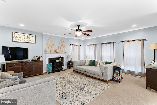  - living area with ceiling fan, carpet, recessed lighting, and a wood stove