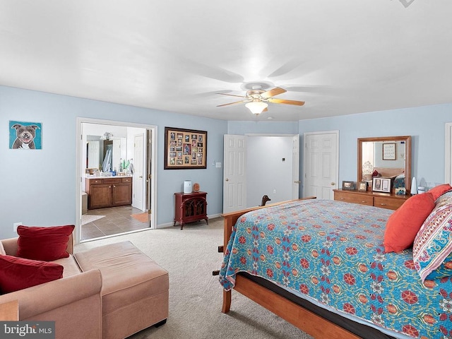  - bedroom featuring light carpet, baseboards, a ceiling fan, and connected bathroom