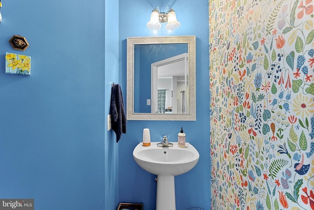  - bathroom featuring a chandelier