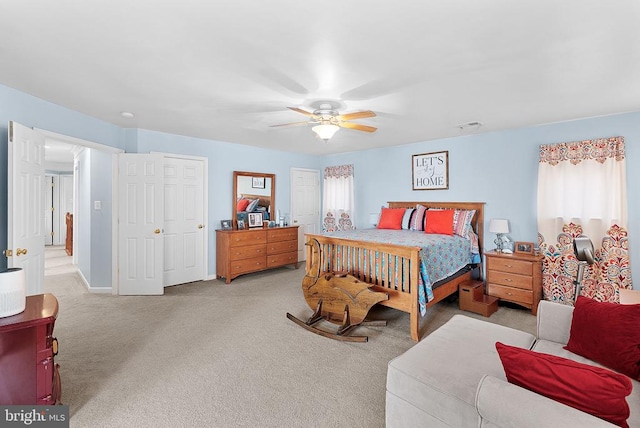  - bedroom with light colored carpet, ceiling fan, and baseboards