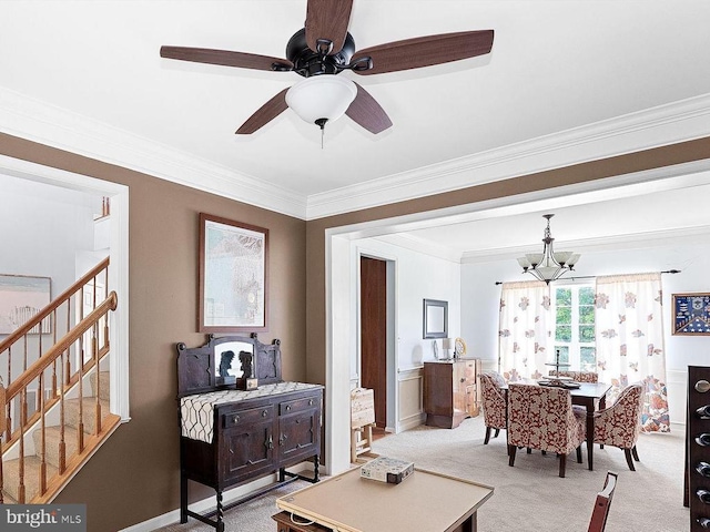  - living room with carpet, a chandelier, stairs, crown molding, and a ceiling fan