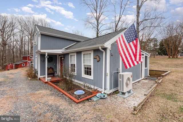 view of home's exterior featuring ac unit and roof with shingles