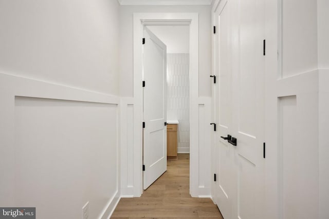 8630 Rosni Way, Fredericksburg, VA 22407 - corridor with light wood finished floors, wainscoting, and a decorative wall