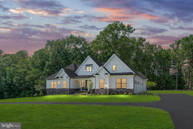 8630 Rosni Way, Fredericksburg, VA 22407 - modern farmhouse with a standing seam roof, board and batten siding, a front lawn, stone siding, and a metal roof