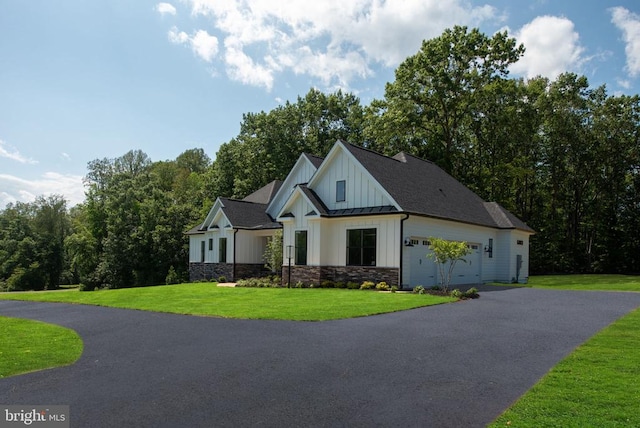 8630 Rosni Way, Fredericksburg, VA 22407 - modern inspired farmhouse with board and batten siding, asphalt driveway, a front lawn, an attached garage, and stone siding