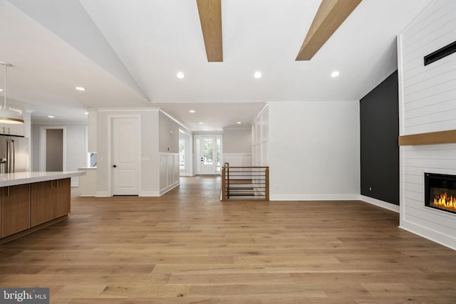 8630 Rosni Way, Fredericksburg, VA 22407 - unfurnished living room featuring vaulted ceiling, a large fireplace, light wood-style flooring, recessed lighting, and ornamental molding