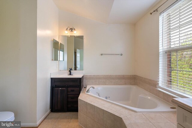 bathroom featuring vanity, a garden tub, tile patterned flooring, and toilet