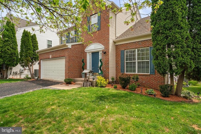 view of front of property featuring brick siding, driveway, and a front yard