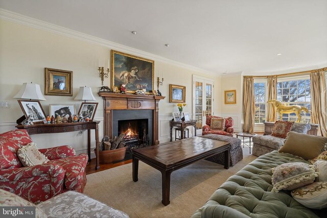  - living room featuring ornamental molding and a lit fireplace