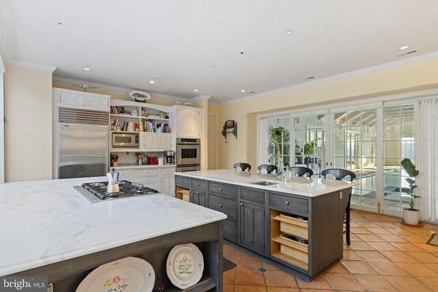  - kitchen featuring open shelves, built in appliances, a kitchen breakfast bar, white cabinets, and crown molding