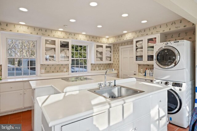  - laundry area with stacked washer / dryer, recessed lighting, tile patterned flooring, and wallpapered walls