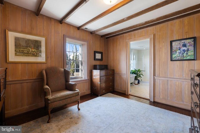  - living area featuring beam ceiling, wood finished floors, and wood walls