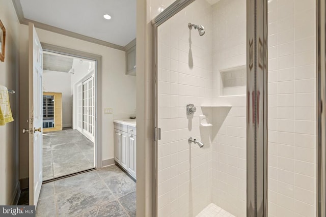  - bathroom with a stall shower, vanity, and ornamental molding