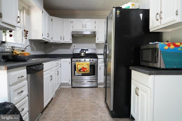 214 Culpeper St W, Culpeper, VA 22701 - kitchen featuring appliances with stainless steel finishes, under cabinet range hood, white cabinetry, dark countertops, and ornamental molding